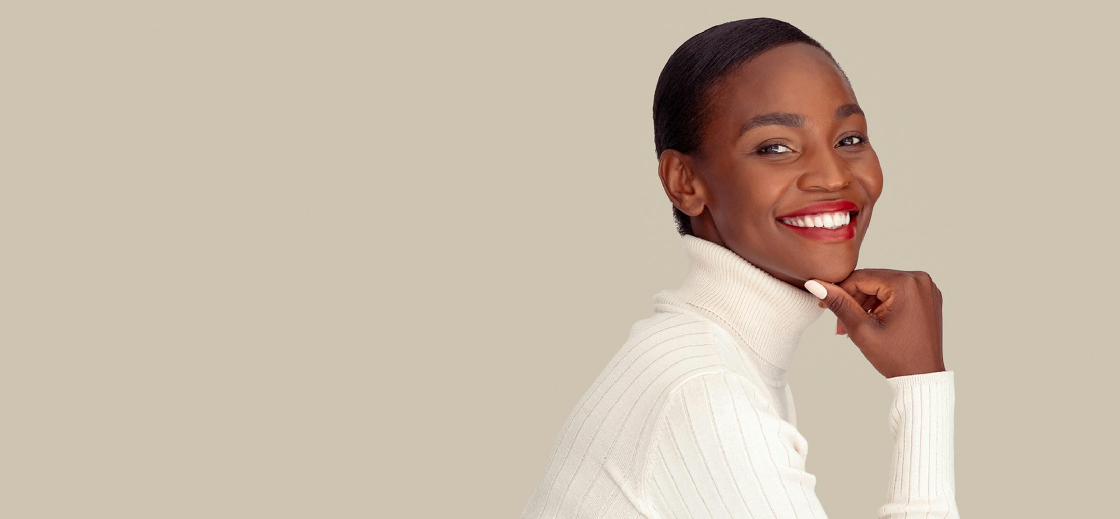 Woman in a white turtle neck smiling