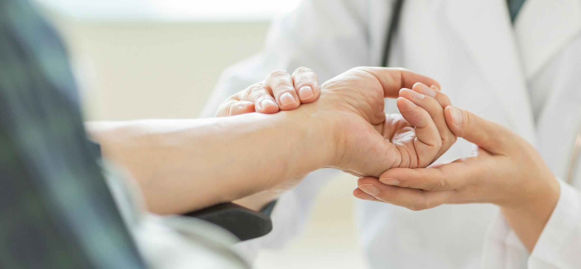 Doctor looking at a patients hand