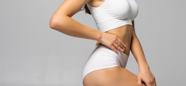 Woman in her underwear with her hand on her hip