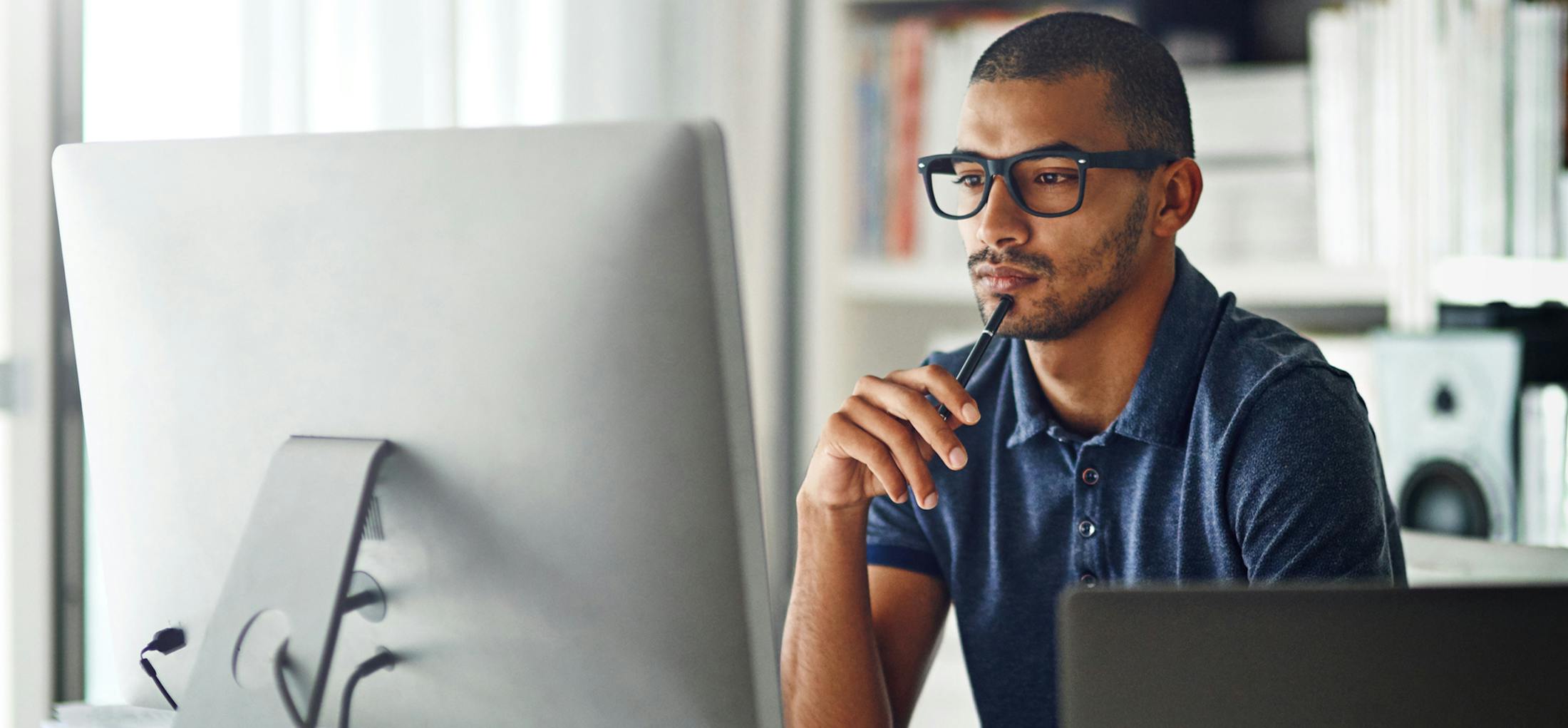 Man sitting in front of his desktop computer