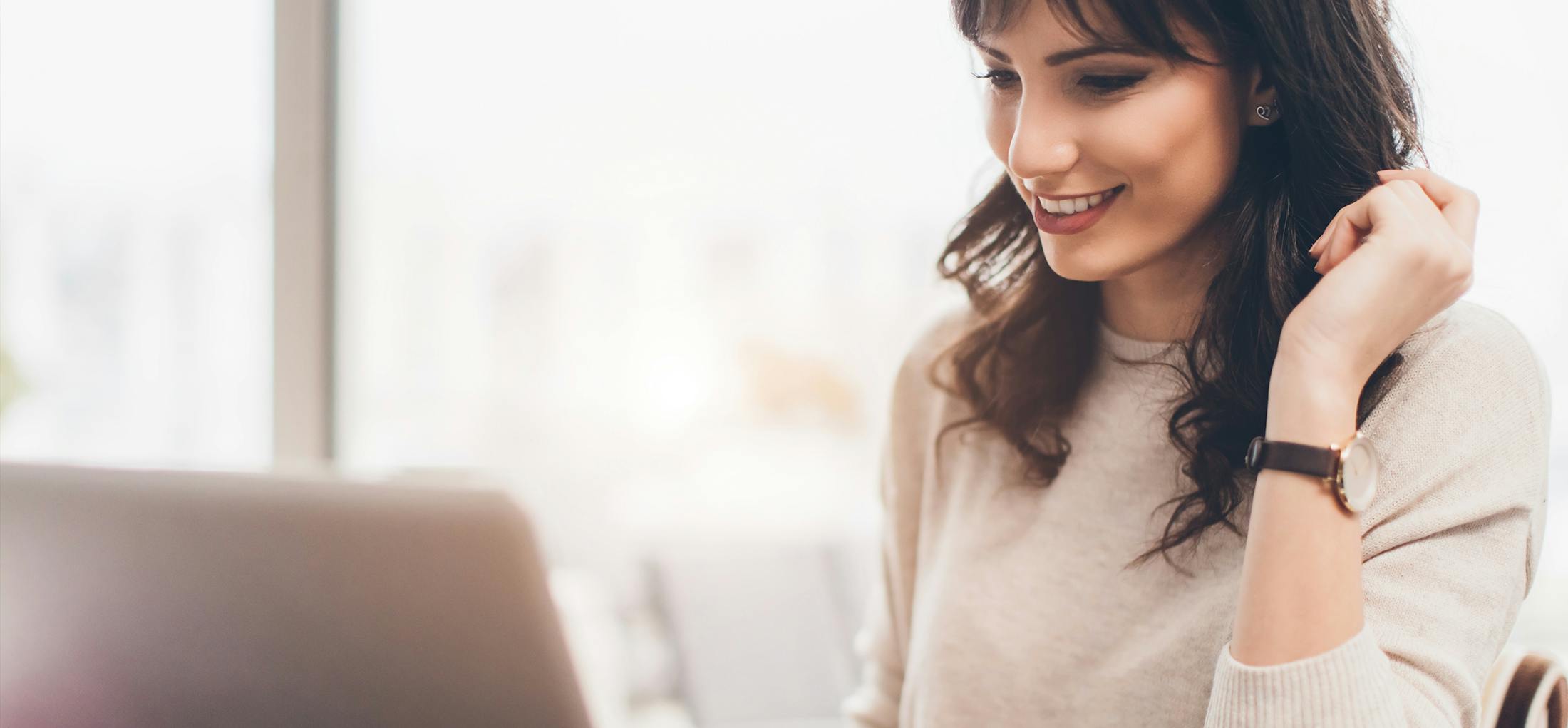 Woman sitting at a desk in front of a computer