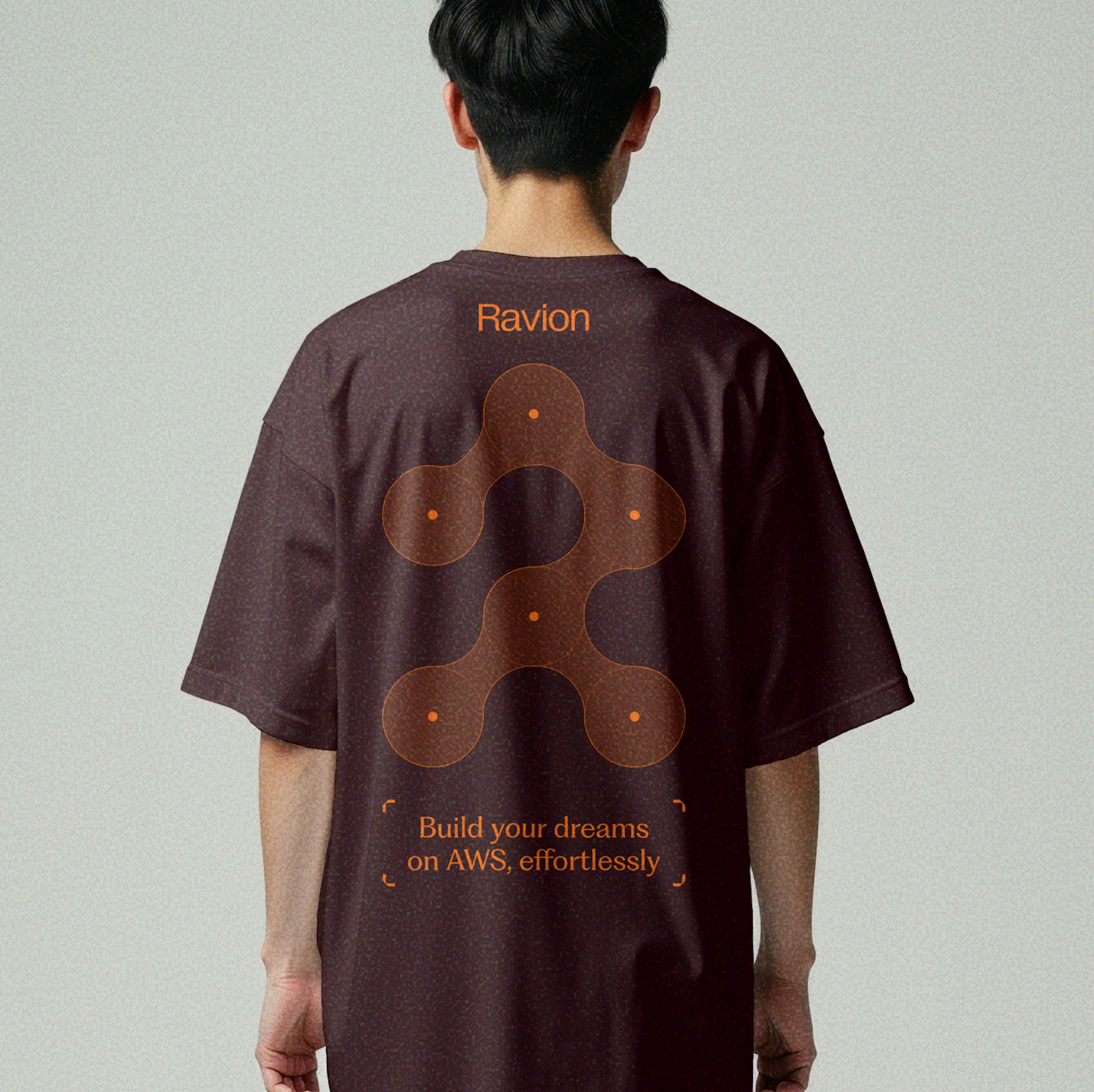 Person wearing a burgundy Ravion-branded t-shirt