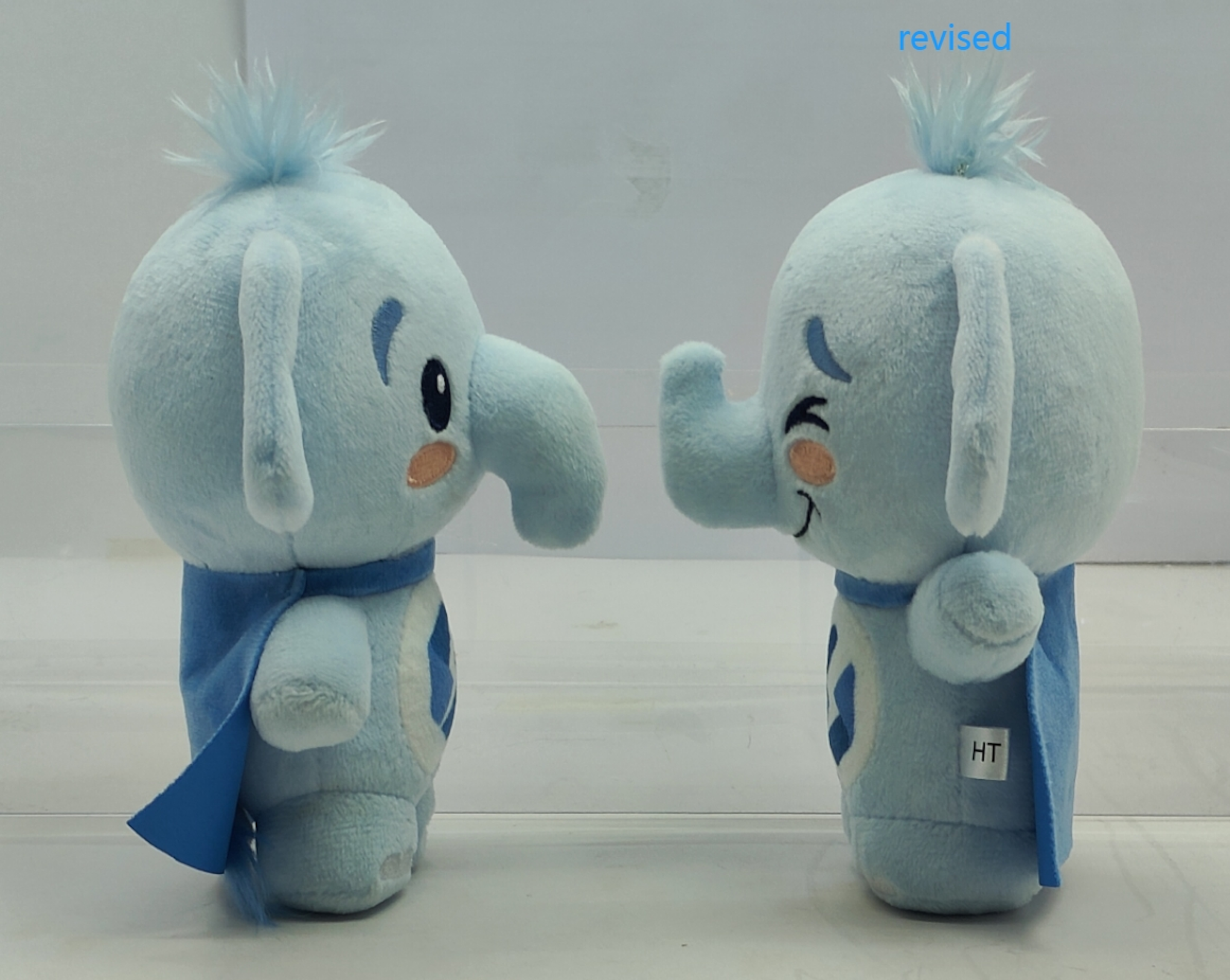 Two physical prototype samples of the Stellate plushie side by side, one tagged for quality control review