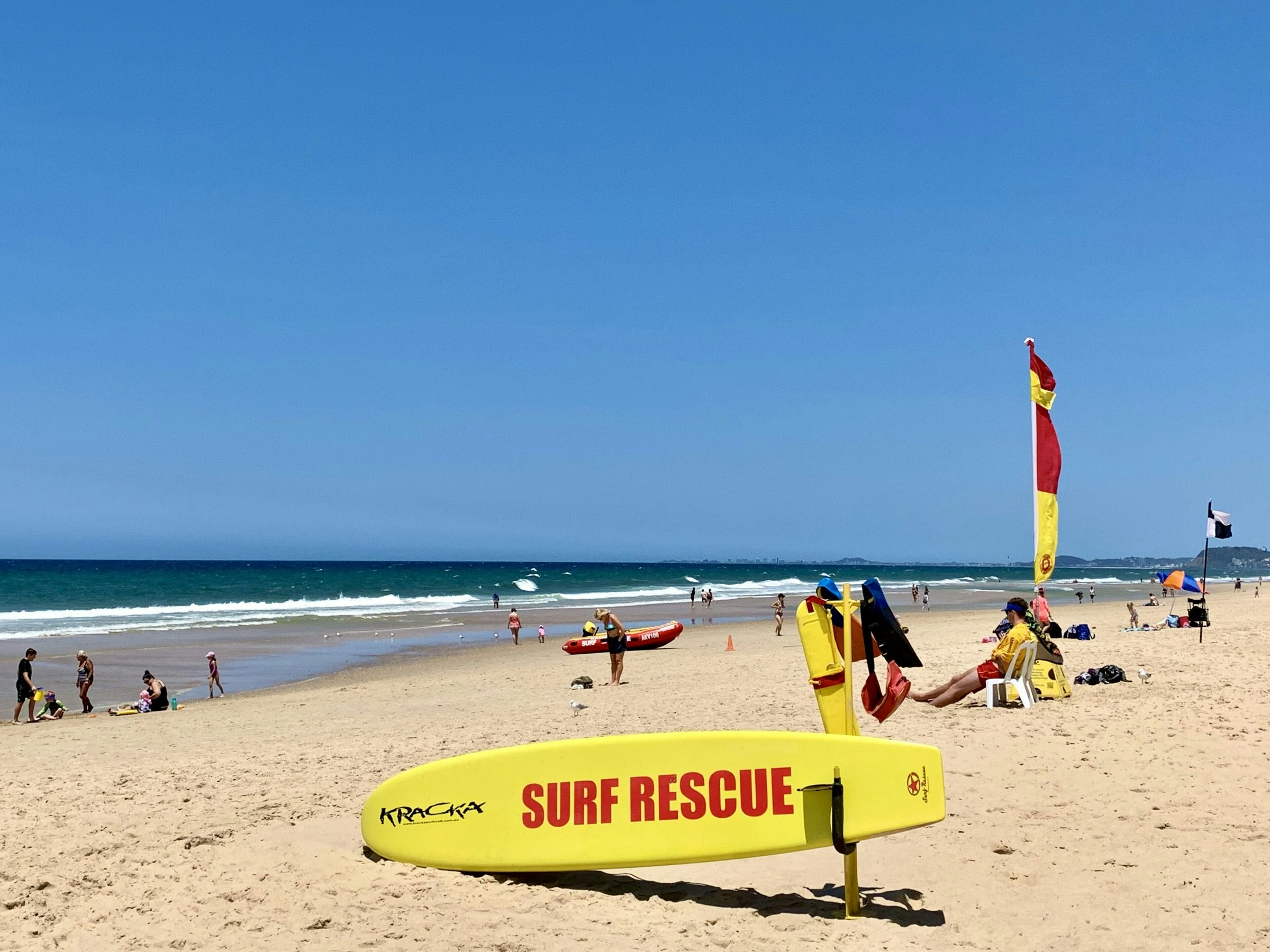 Surf rescue board and patrol flags on Kurrawa Beach, Broadbeach