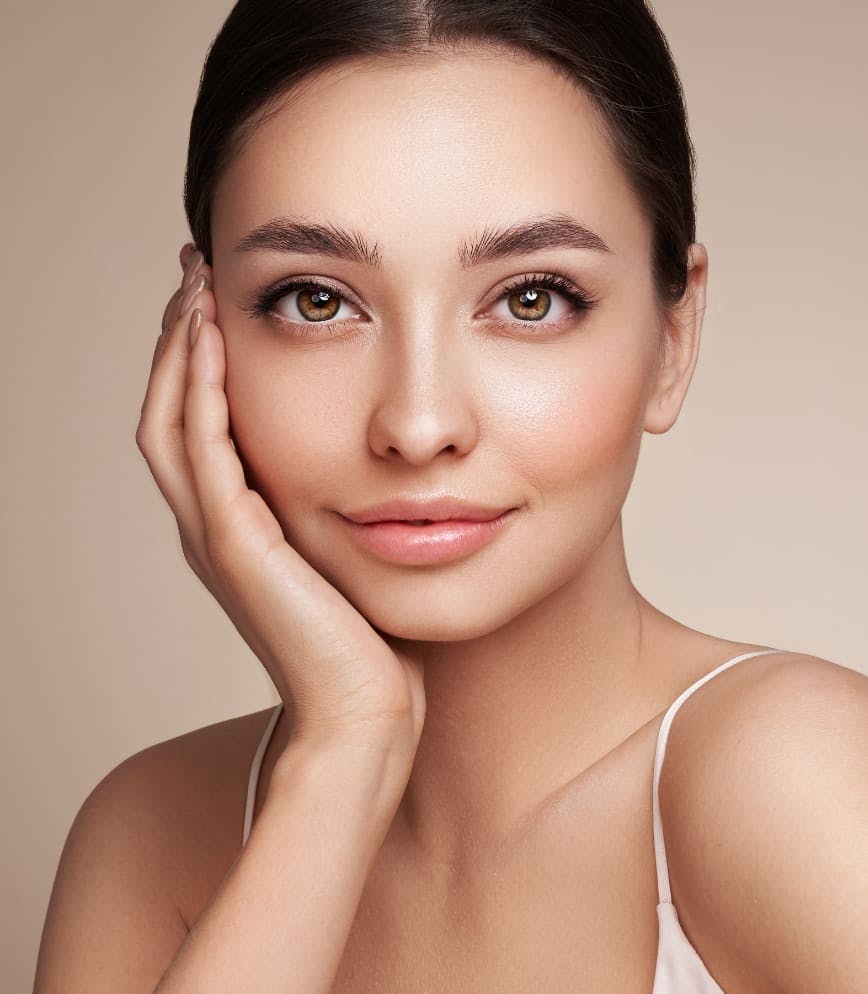 woman with her hand to her cheek