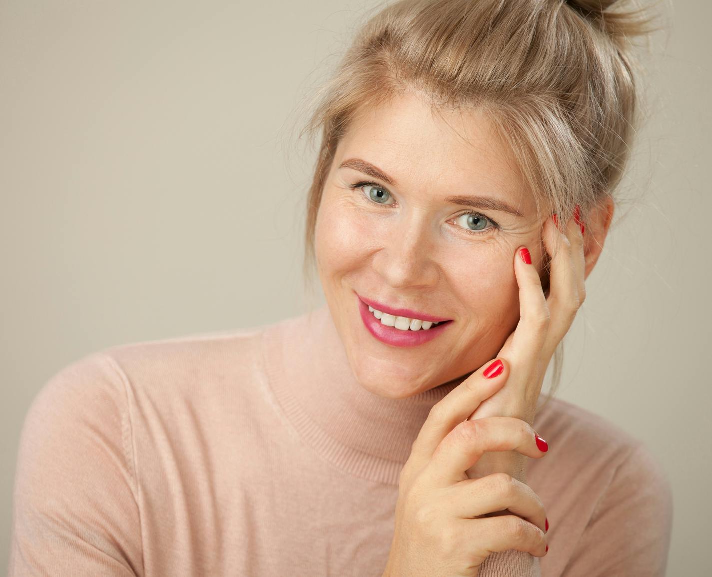 woman with red nail polish on