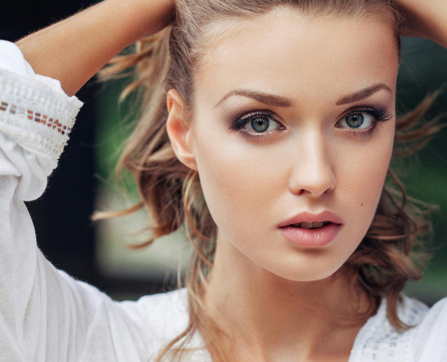 woman pulling her hair back