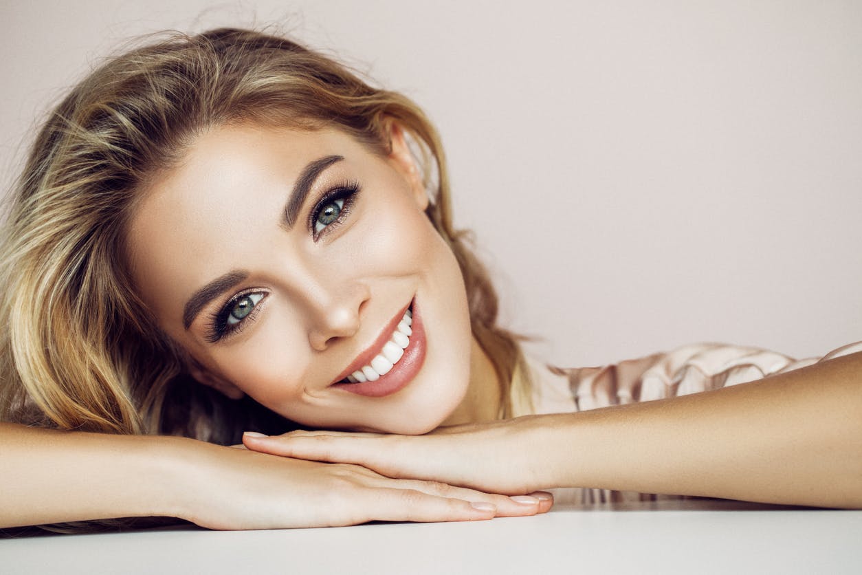 Beautiful Women Smiling With Her Head Titled
