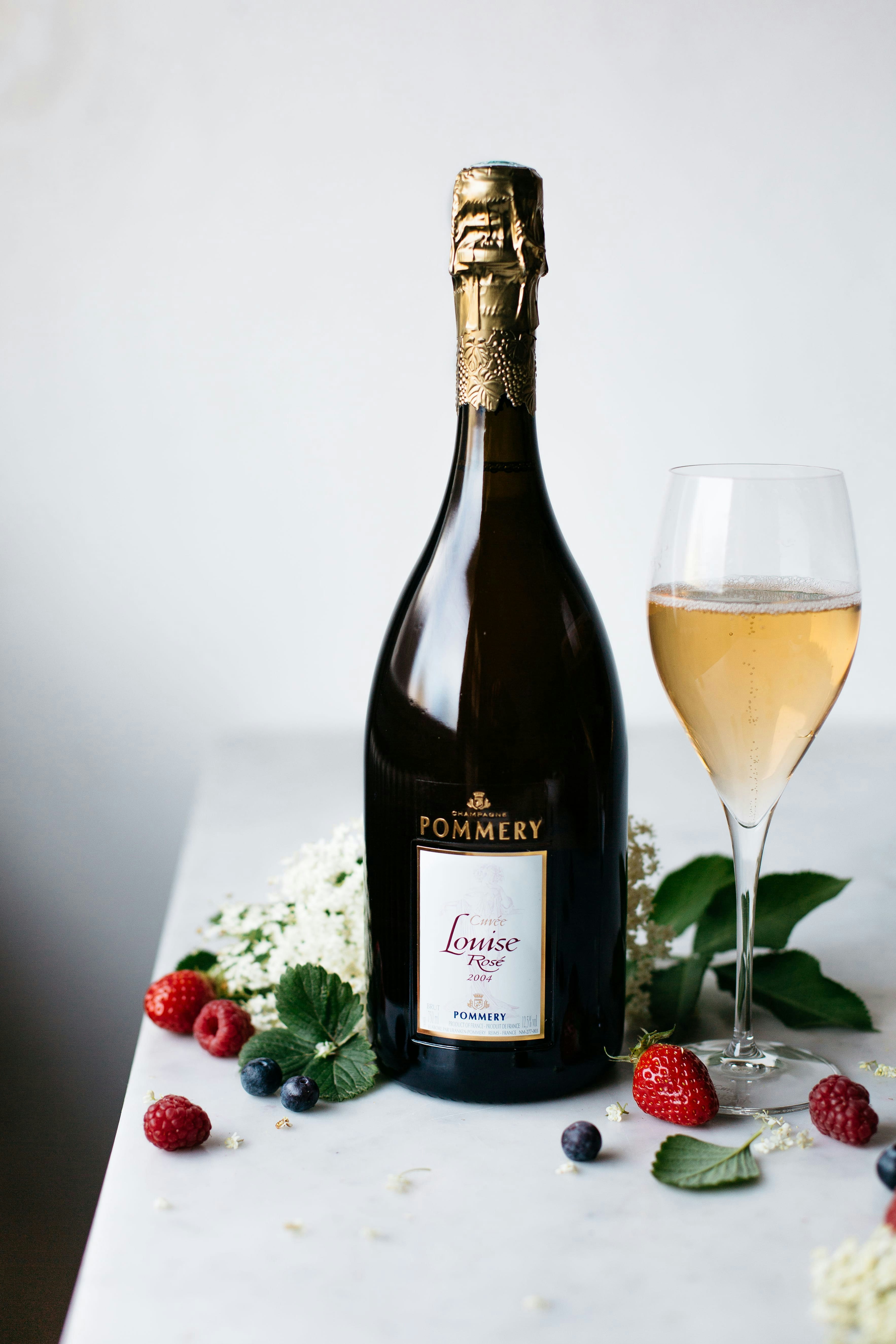 Bottle of Pommery Louise rosé 2004 75cl with glass and fruits