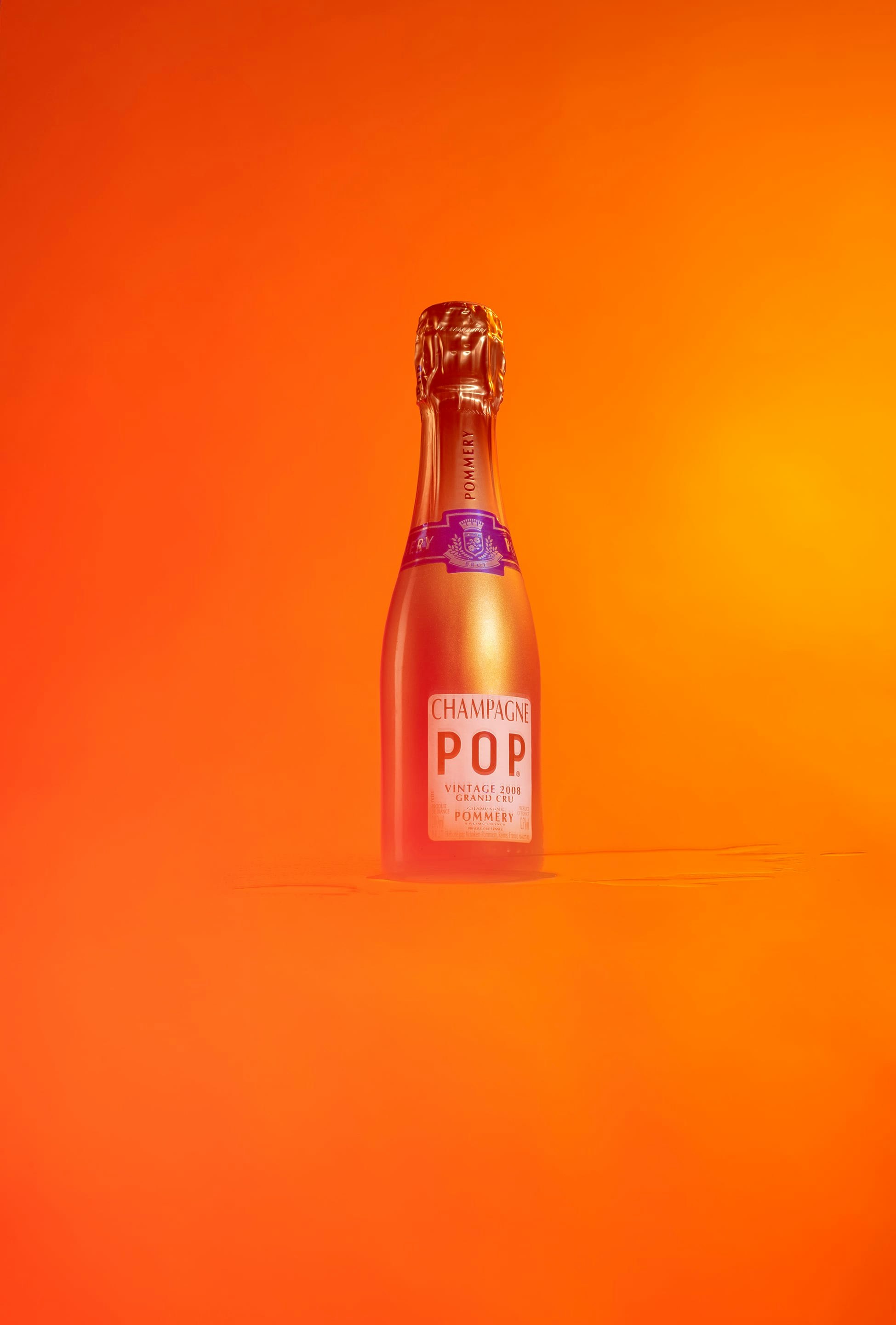 Quarter Bottle of Pommery Pop Gold 20cl on orange and red font