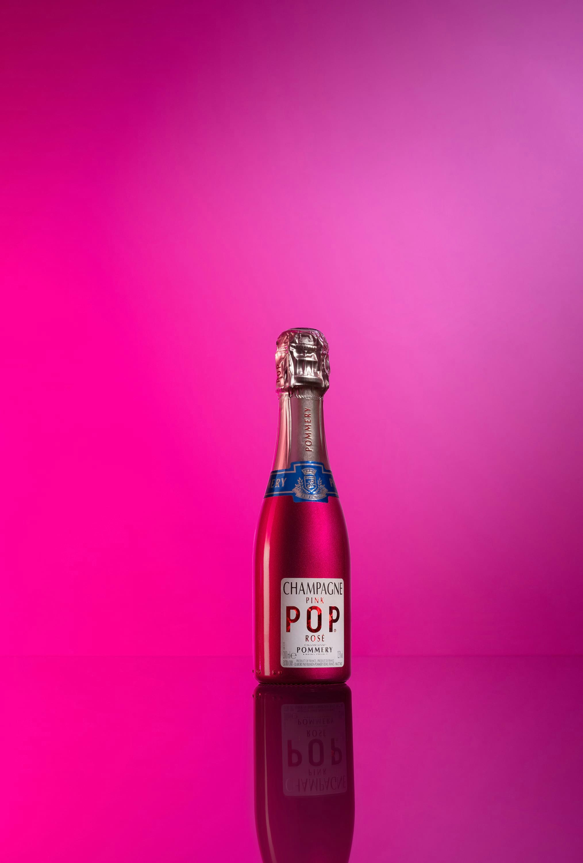 Quarter bottle of Pommery Pink Pop 20cl on pink font