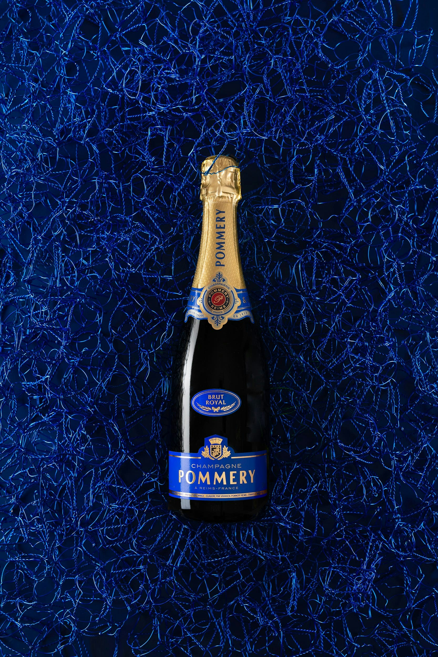 Bottle of Pommery Brut Royal 75cl on blue font