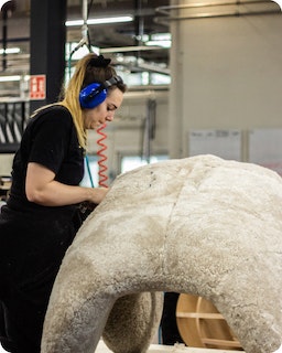 Manufacturing A woman works in the manufacturing of a giant plushie