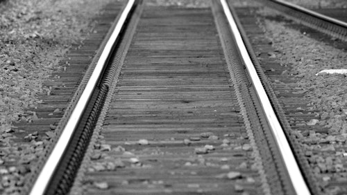 Schwarz-Weiß-Foto von Eisenbahnschienen in Groenekan, das Perspektive und Tiefe zeigt.