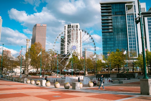 Tagesansicht des Centennial Olympic Park mit Wolkenkratzern und Riesenrad in Atlanta, Georgia.