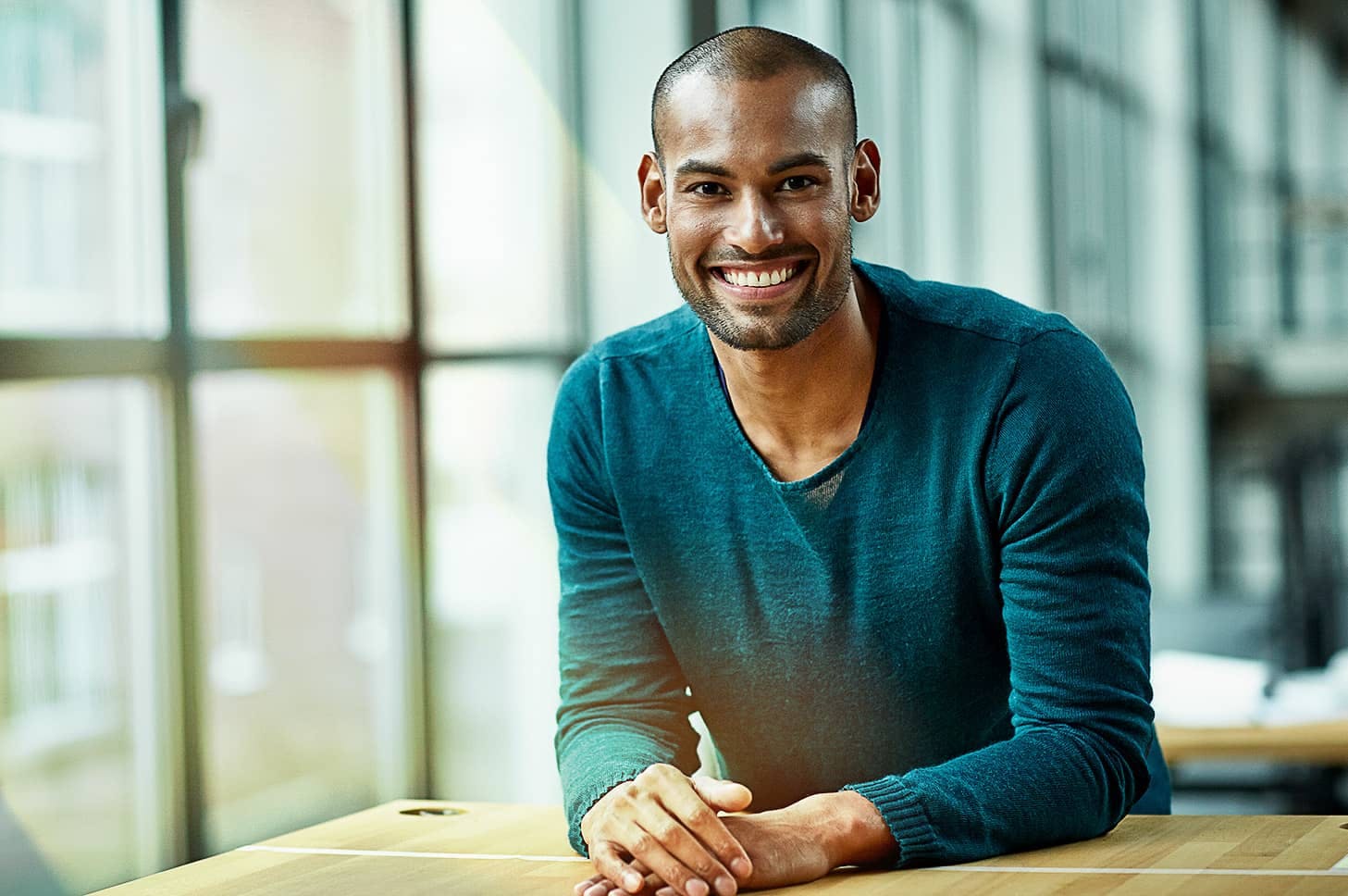 Black gentleman looking straight with a big smile