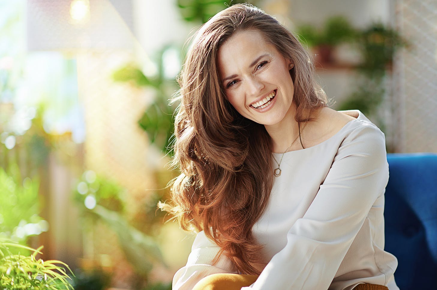 woman smiling and looking over her shoulder to the side