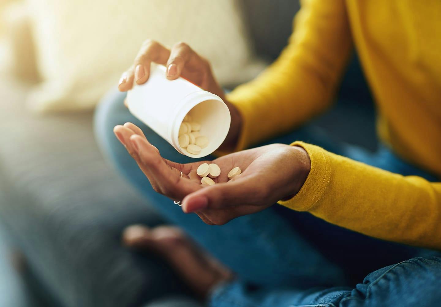 Woman pouring pills into her hand