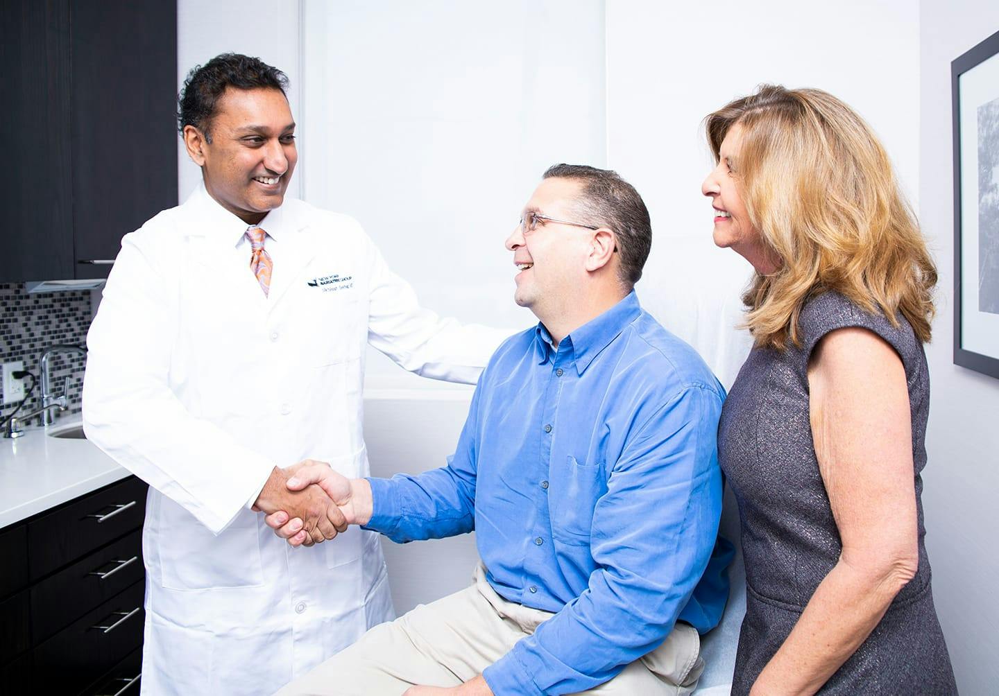 Man and woman speaking with doctor
