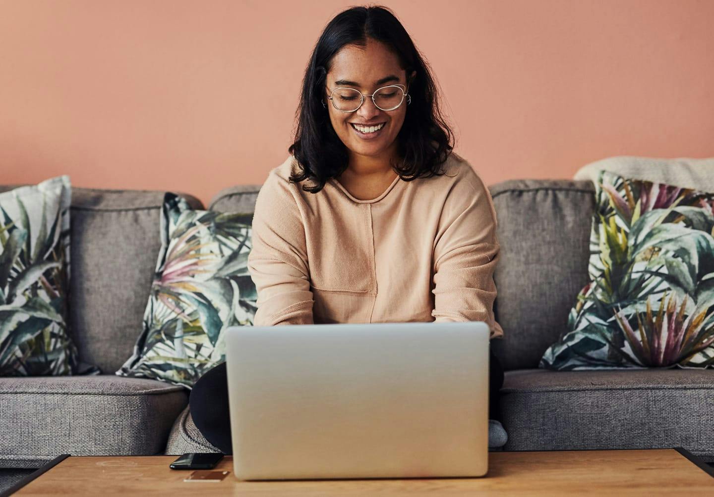 woman smiling while on a laptop