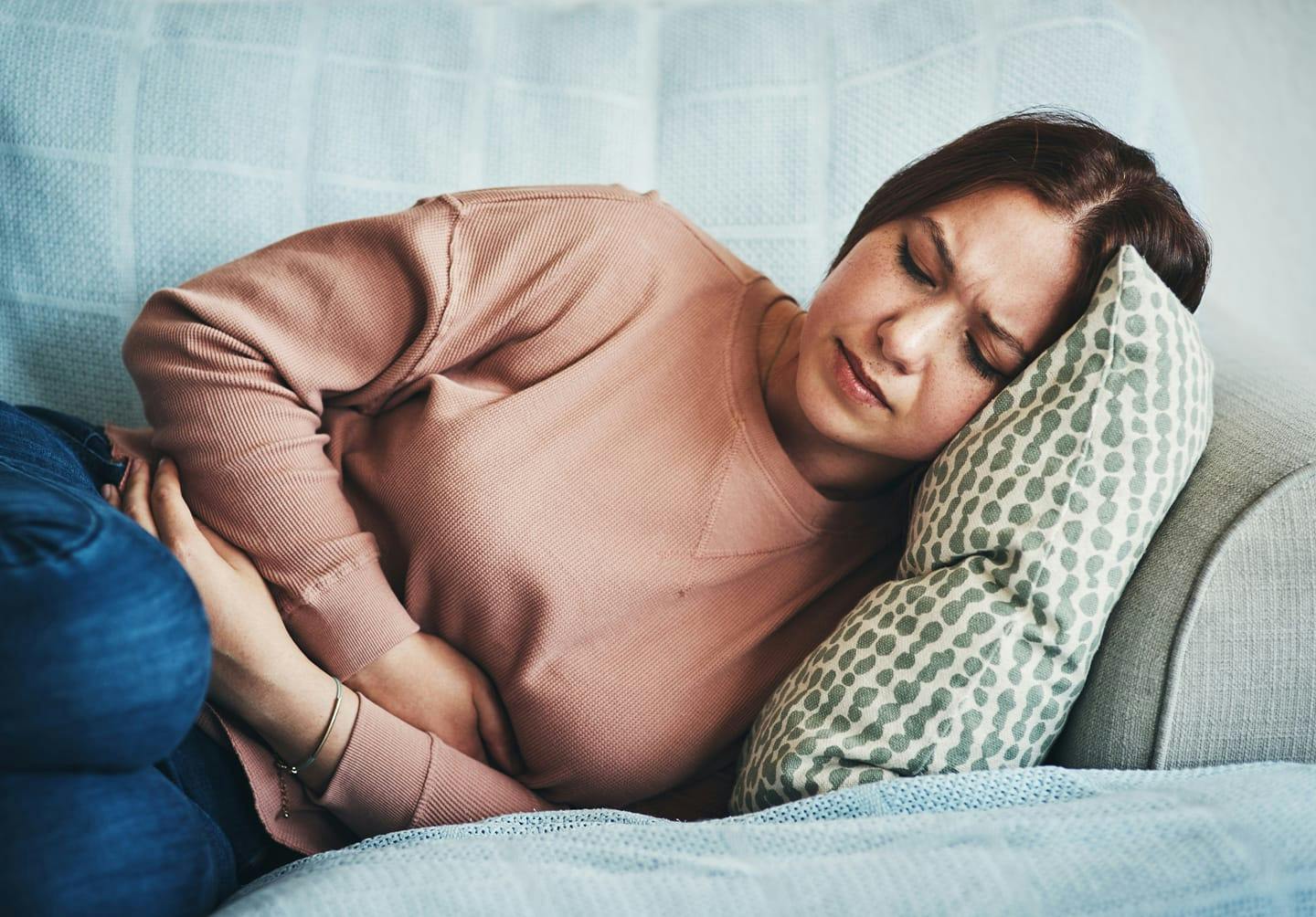 Woman holding her stomach in discomfort