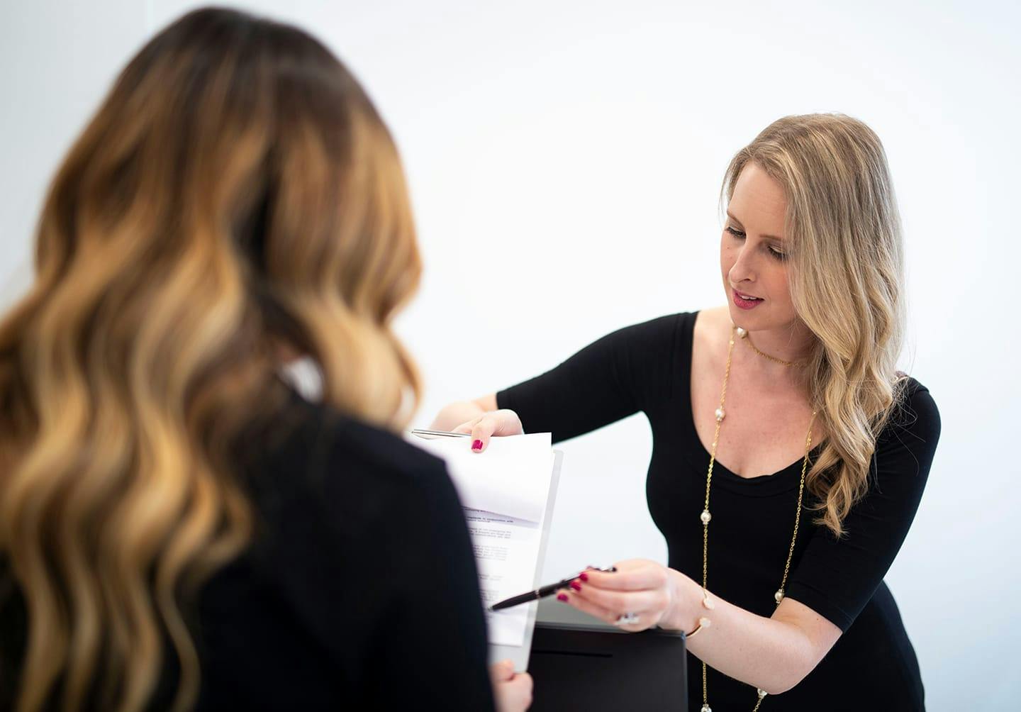 Woman showing paper to patient