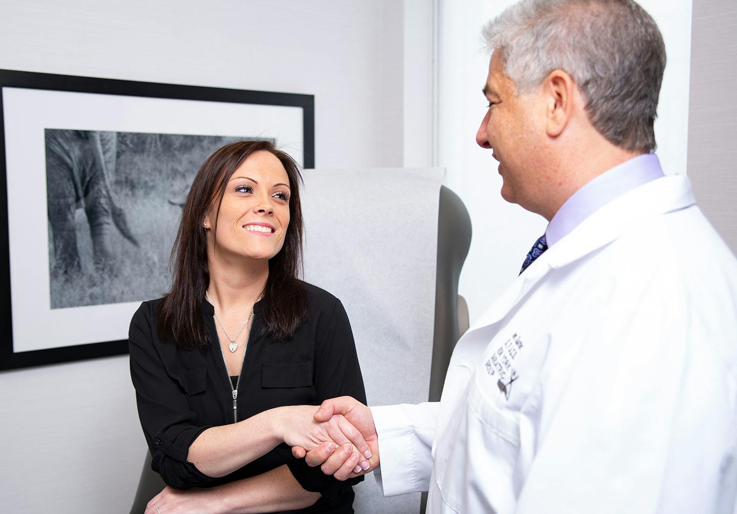 Woman shaking doctor's hand