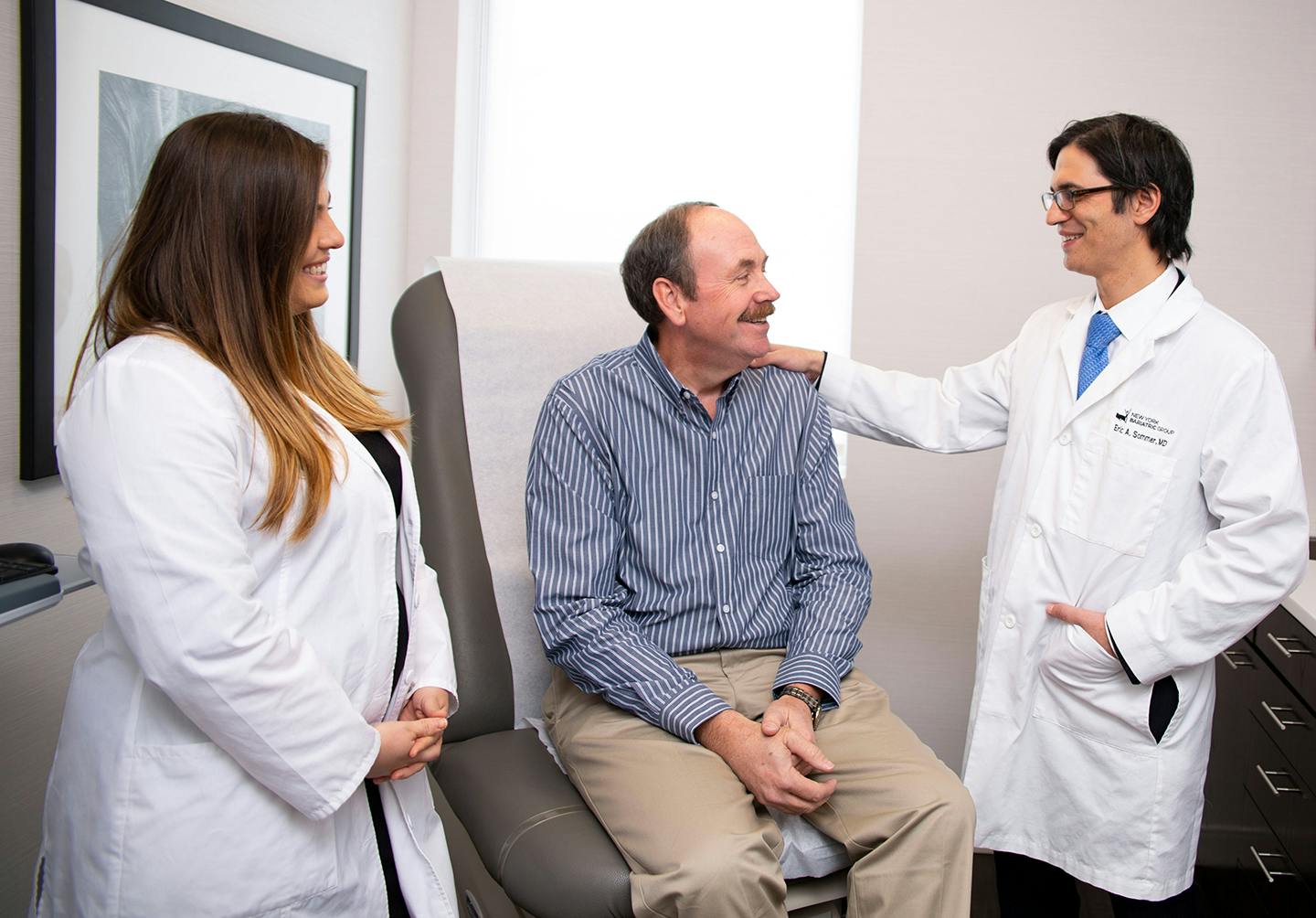 Doctor with his hand on man's shoulder