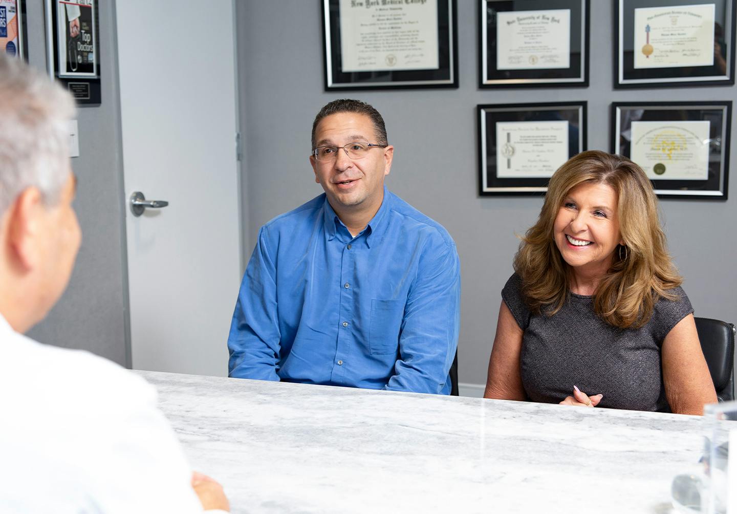 Patients sitting with a doctor