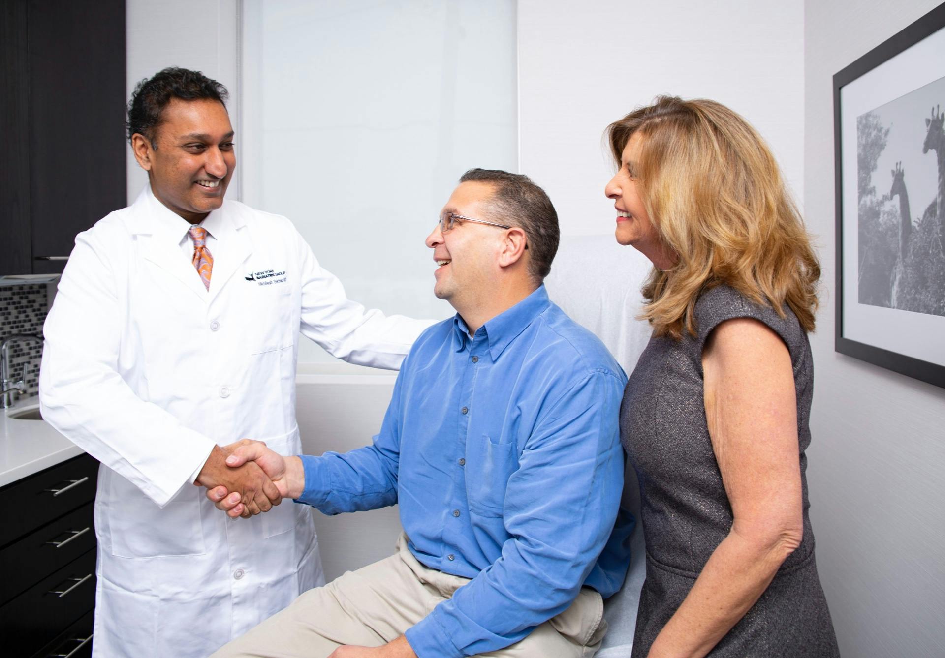 Man and woman speaking with doctor