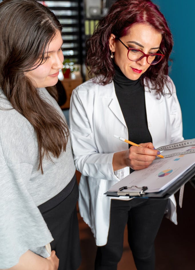 Doctor showing woman a chart