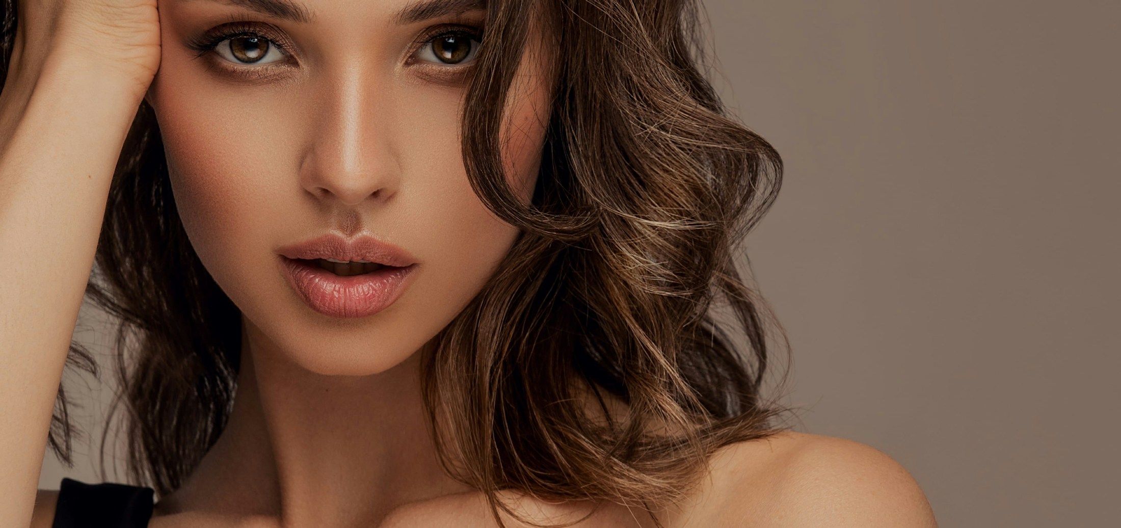 Beautiful woman with brown curly hair, mouth slightly open