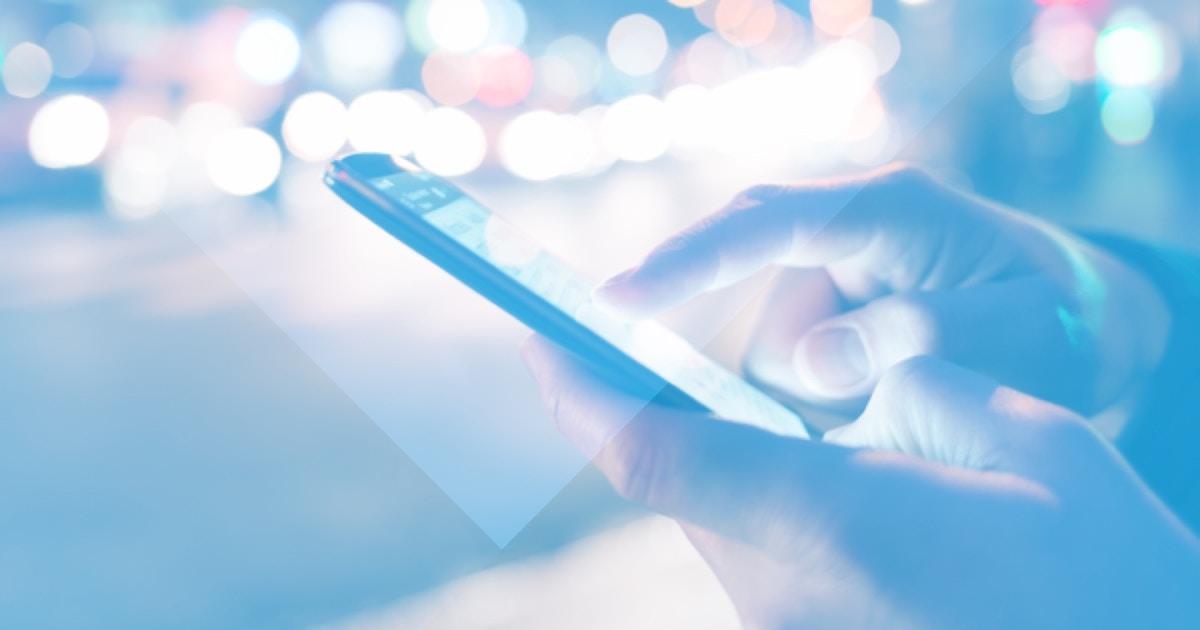 7 Benefits of a Sobriety Tracker Closeup of a recovering addict's hands using a sobriety tracker app outside a club.