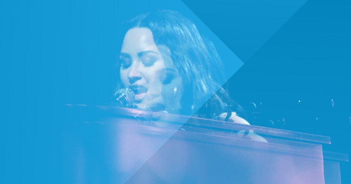 Demi Lovato singing at a concert