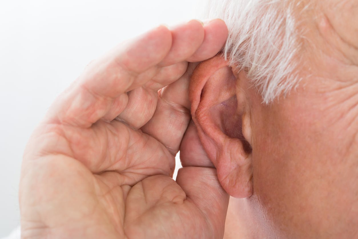 Closeup of person cupping their ear.