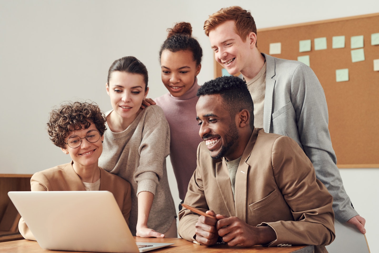 Group of people looking at laptop