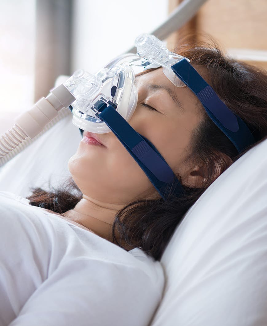 Female patient using sleep apnea treatment machine