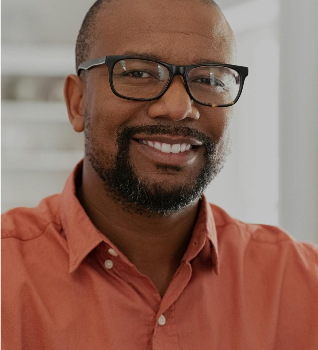 Man wearing glasses, smiling