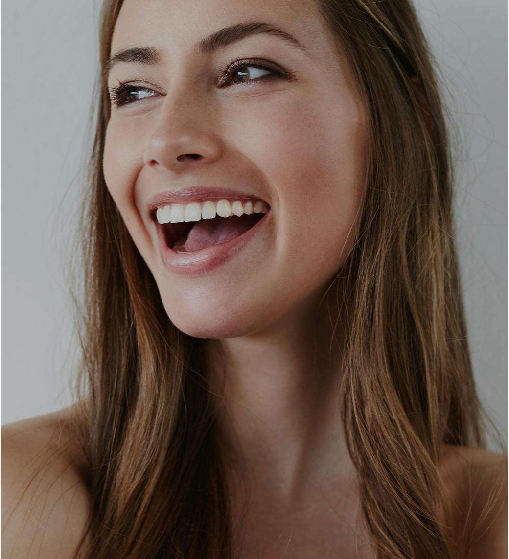 Woman smiling with her mouth open, looking to the side