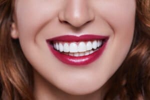 woman with red/pink lipstick smiling