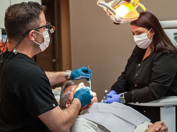 Staff working on patient at Admira Dentistry
