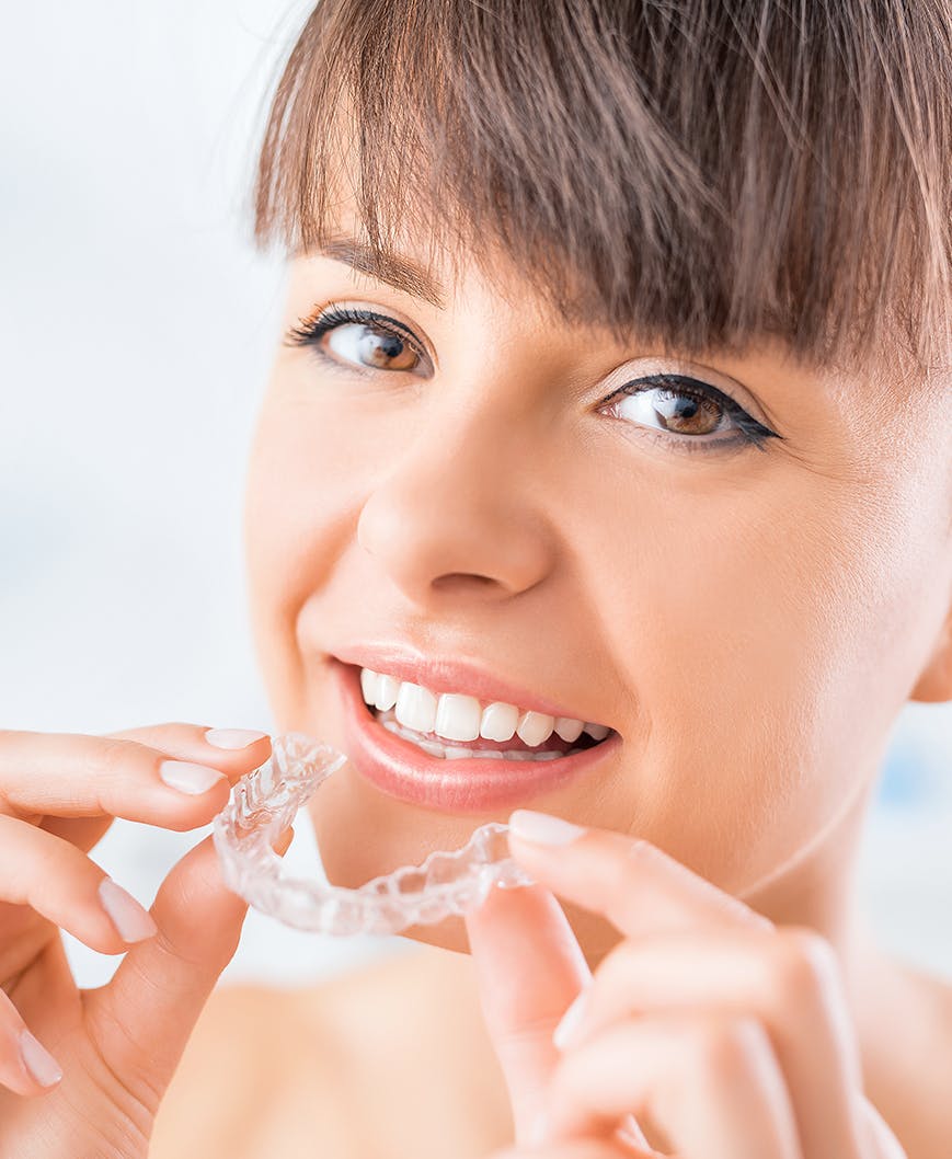 Woman with clear teeth aligners