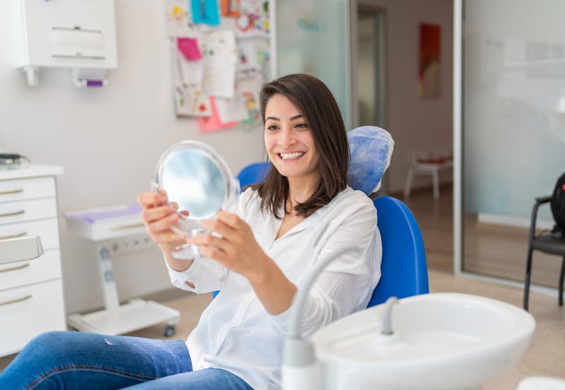 Woman in dentist office after dental implants