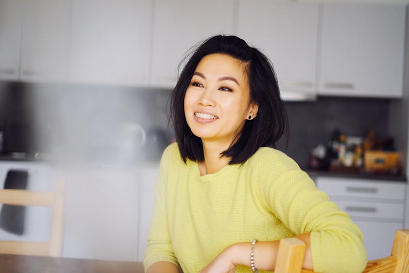 model in yellow sweater with braces on