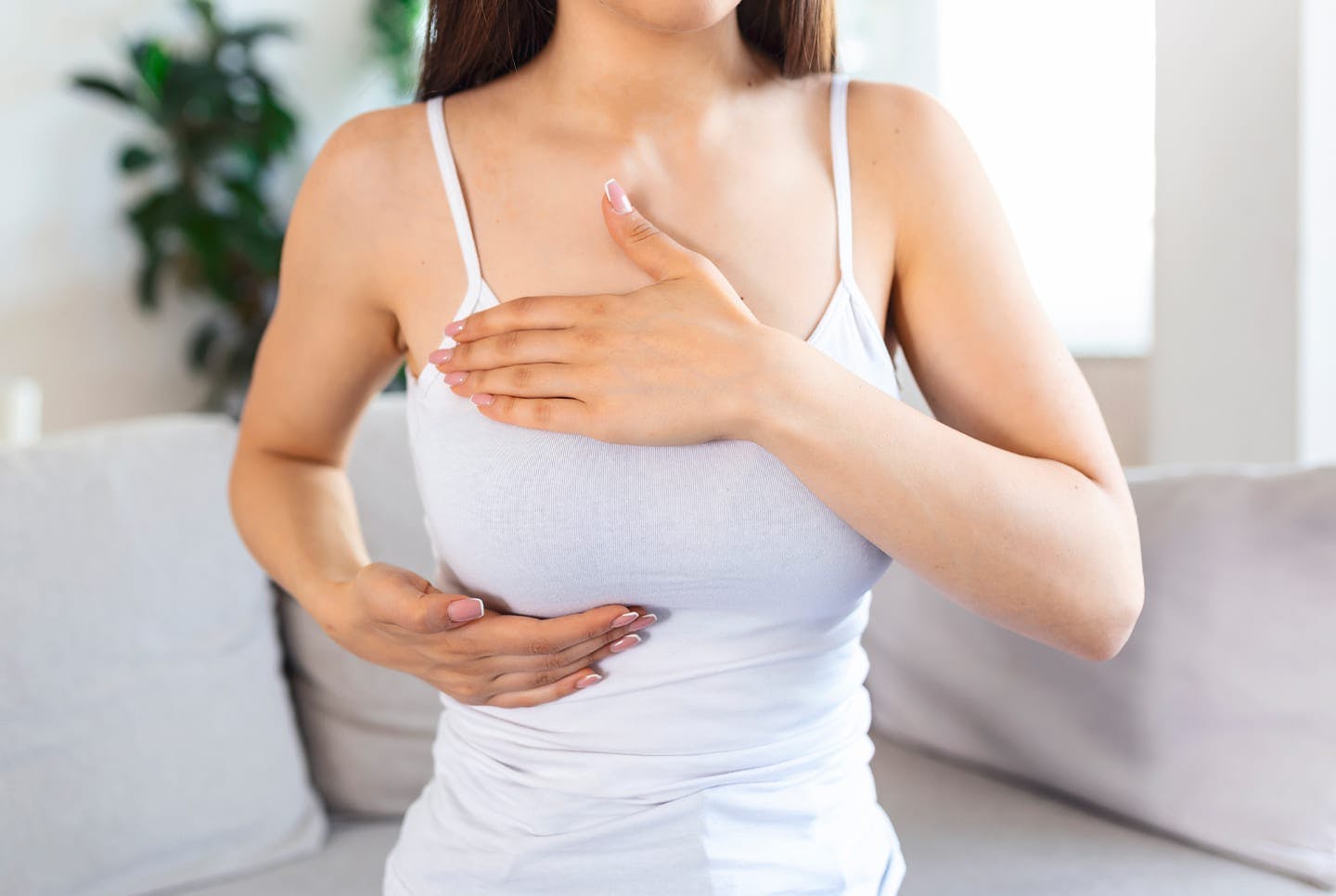 woman feel breast with both hands