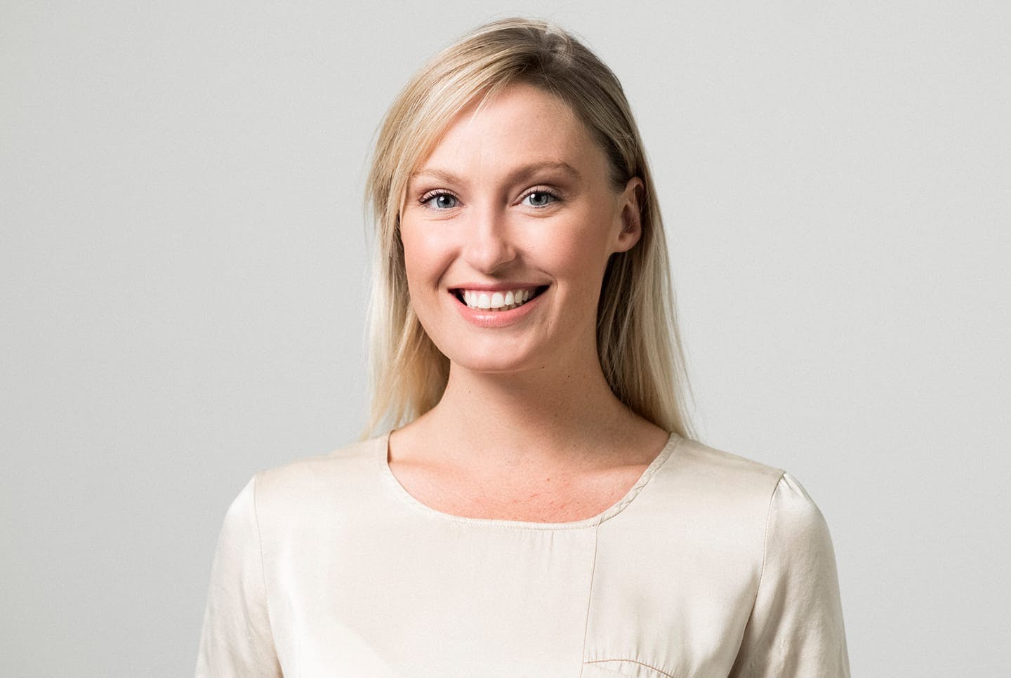 blonde woman in creme colored top