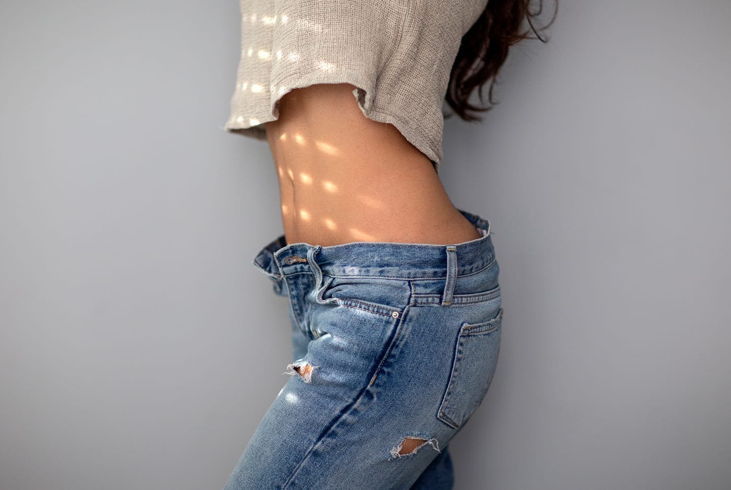 woman in jeans showing midriff