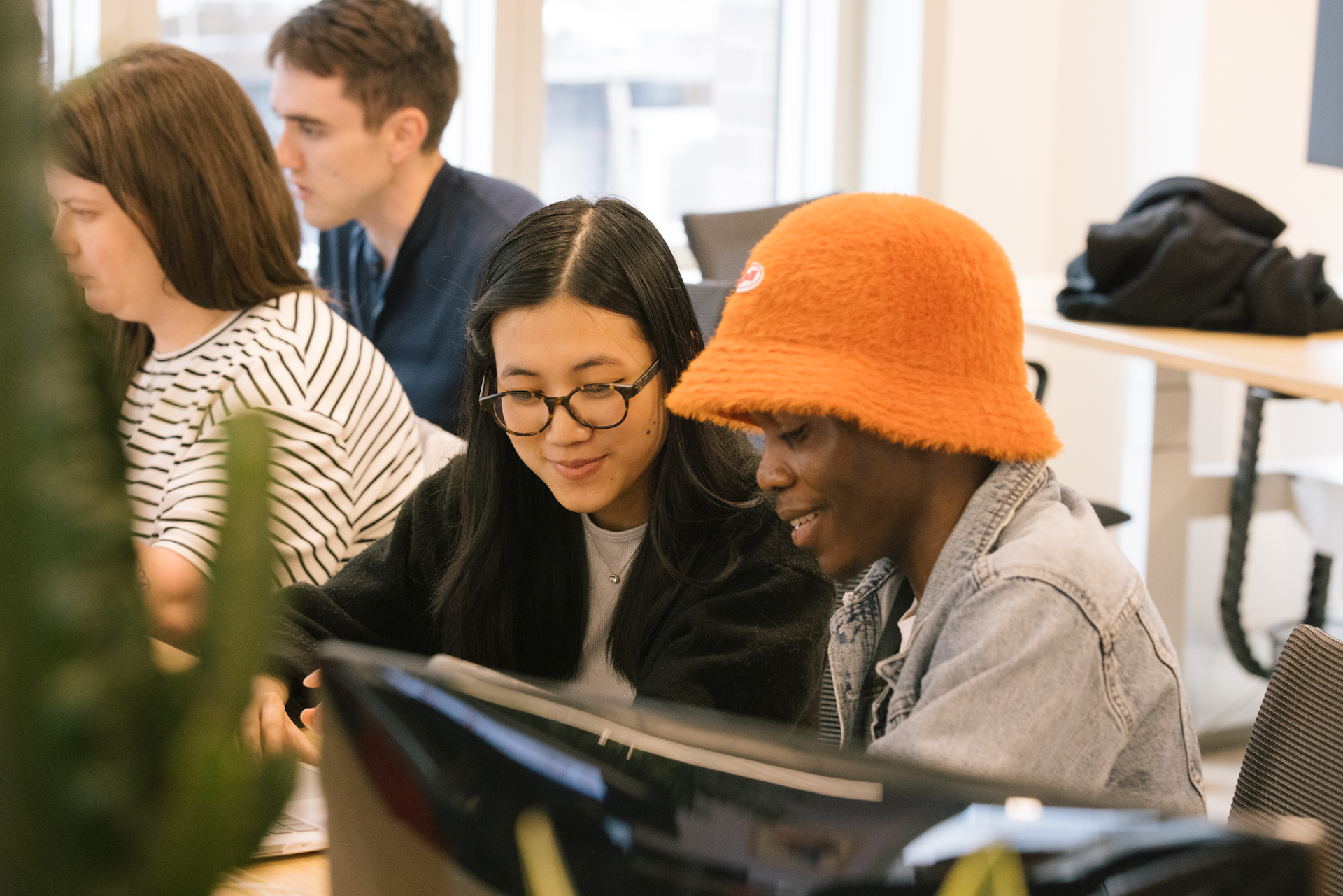 Two software developers working closely together to solve a problem