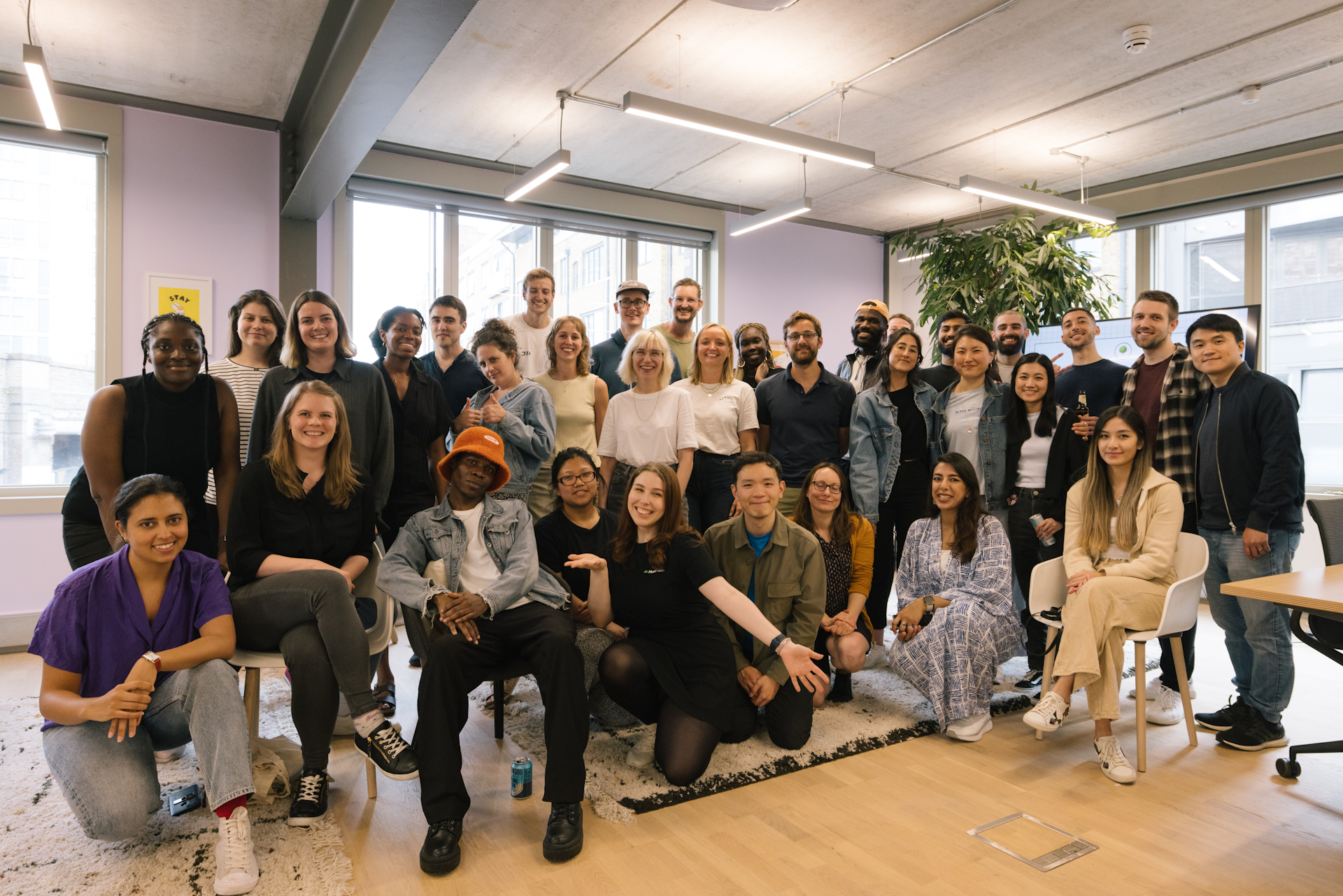 A large and diverse group of developers smiling for the camera