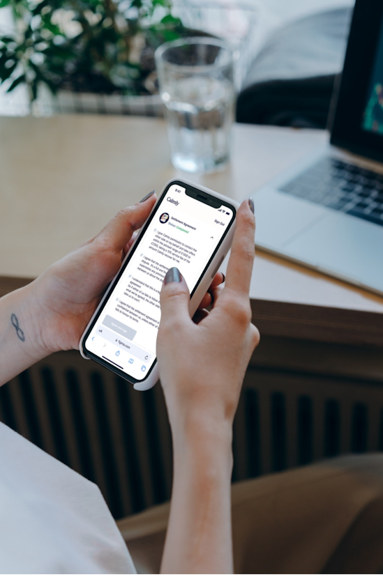 A person is scrolling through Calmly's settlement agreement on their Iphone